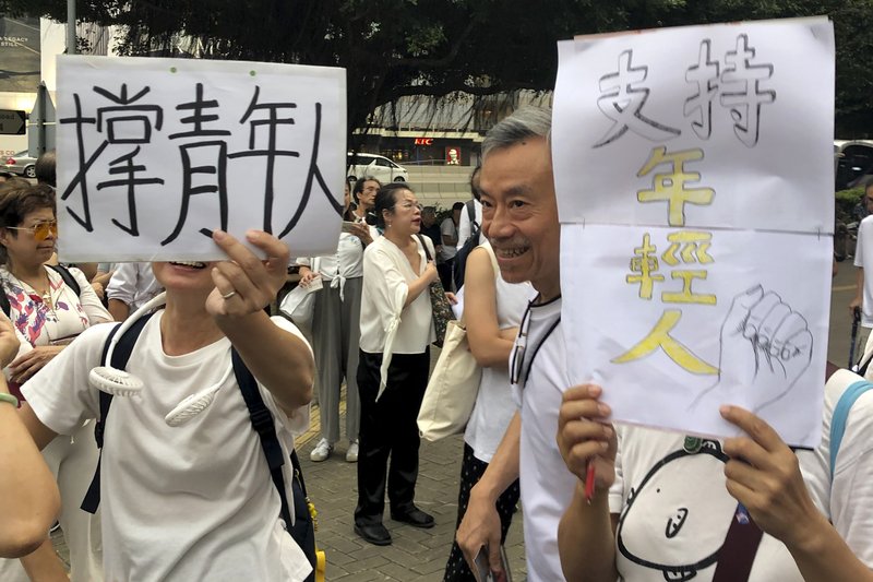 Elderly Hong Kong residents with posters that read "Support young people" during a march in Hong Kong on Wednesday, July 17, 2019. Some 2,000 Hong Kong senior citizens, including a popular actress, marched Wednesday in a show of support for youths at the forefront of monthlong protests against a contentious extradition bill in the semi-autonomous Chinese territory.(AP Photo/Phoebe Lai)