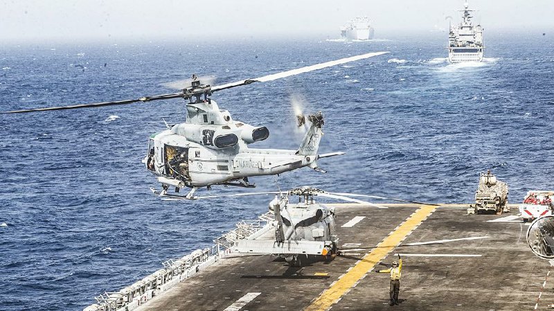 A helicopter takes off Thursday from the flight deck of the USS Boxer, the amphibious assault ship that officials said took out an Iranian drone in the Strait of Hormuz as it flew too close to the ship. 