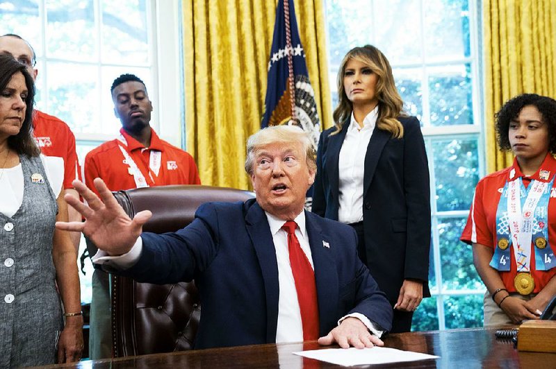 President Donald Trump, along with his wife, Melania, meets Thursday with U.S. Special Olympics athletes in the Oval Office. He said he disagreed with a campaign crowd’s “send her back” chant Wednesday but continued to criticize four female Democratic freshman lawmakers, including Rep. Ilhan Omar of Minnesota. “They have such hatred,” he said of the four women. 