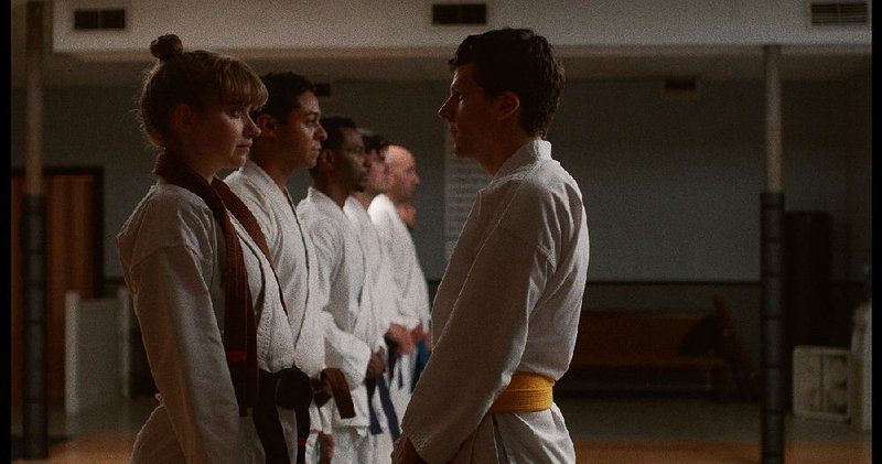 Brown belt Anna (Imogen Poots) and yellow belt Casey (Jesse Eisenberg) know something’s amiss with their Sensei in The Art of Self-Defense, a darkly comic critique of toxic masculinity. 