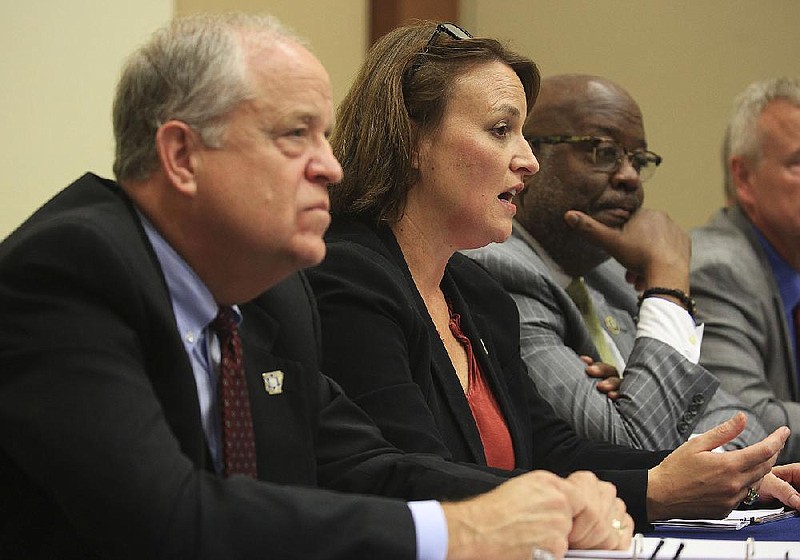 FILE - Arkansas Public Safety Secretary Jami Cook (center), along with Arkansas State Police Director Col. Bill Bryant (left) and Little Rock Police Chief Keith Humphrey discuss new training programs for law enforcement officers dealing with missing persons cases Thursday, July 18, 2019, in Benton. (Arkansas Democrat-Gazette/Staton Breidenthal)