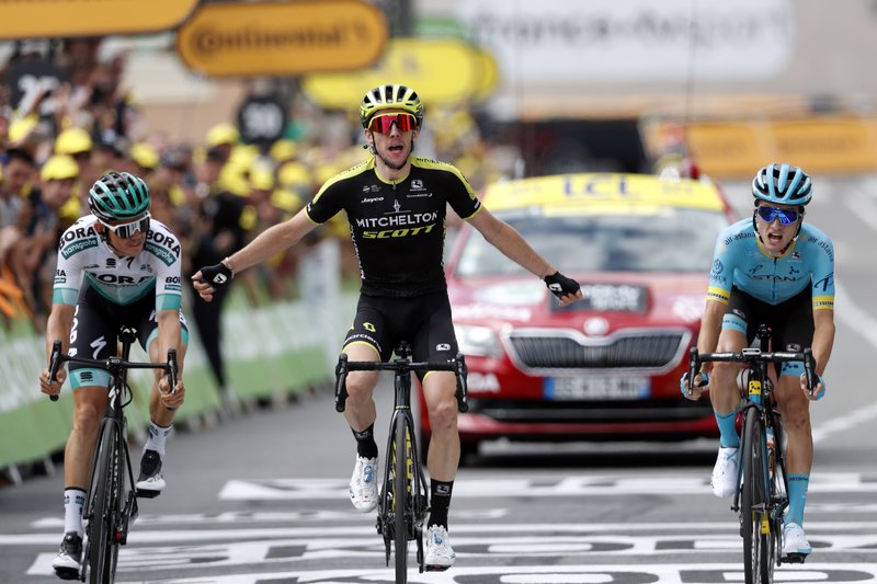 DYNAMIC TRIO: Britain's Simon Yates, center, surrounded by Spain's Pello Bilbao Lopez De Armentia, right, and Austria's Gregor Muhlberger, celebrates as he crosses the finish line Thursday to win the twelfth stage of the Tour de France, over 209,5 kilometers (130 miles) with start in Toulouse and finish in Bagneres-de-Bigorre, France.