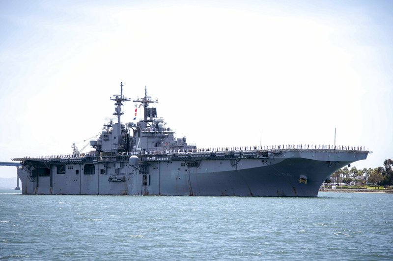 In this May 1, 2019, photo provided by the U.S. Navy, the amphibious assault ship USS Boxer (LHD 4) transits the San Diego Bay in San Diego, Calif. President Donald Trump says the USS Boxer destroyed an Iranian drone in the Strait of Hormuz amid heightened tensions between the two countries. Trump says it's the latest "hostile" action by Iran. (Mass Communication Specialist 2nd Class Jesse Monford/U.S. Navy via AP)