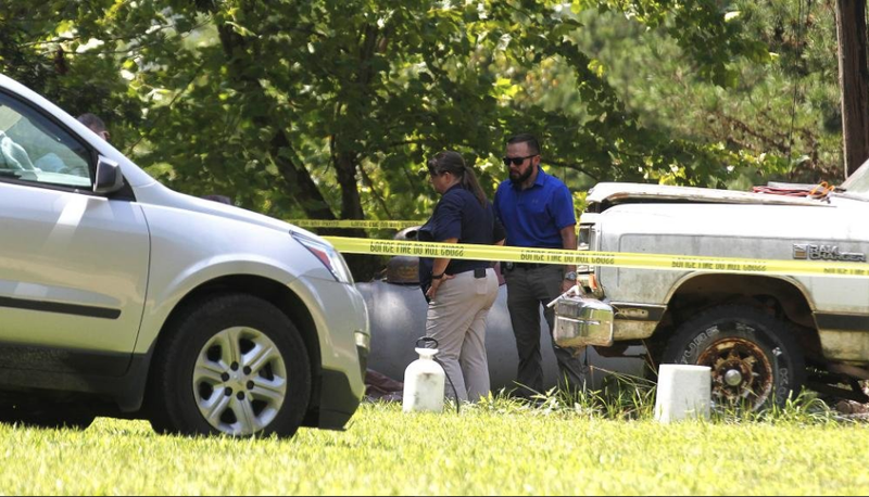 Deputies with the Stone County Sheriff's Department and Arkansas State Police investigate an officer involved shooting that a Stone County deputy was killed on Thursday, July 18, 2019, in Leslie. 