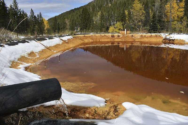 Water contaminated with arsenic, lead and zinc flows out of a mine last fall near Rimini, Mont. Environmentalists arguing for the mining-pollution rule had claimed that the proposal would help ensure mining companies would pay to clean up water-fouling spills. 