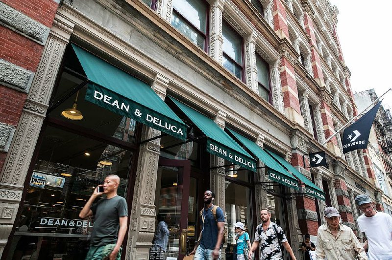 Pedestrians pass a Dean & DeLuca store last week in the SoHo neighborhood of New York City. 