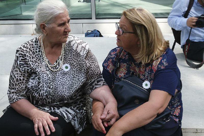 Munira Subasic (left) and Nermina Lakota of the Mothers of Srebrenica organization sit Friday outside the Dutch Supreme Court in The Hague. The Dutch “are responsible and they will always have a stain,” Subasic said after Friday’s ruling. 