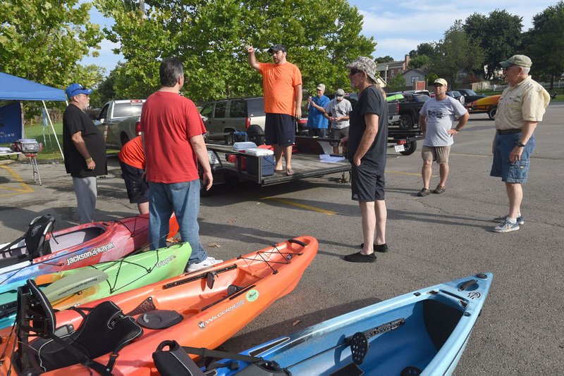 NWA Democrat-Gazette/FLIP PUTTHOFF Anglers get basic safety and fishing information July 8 2017 from Artie Keith, a Heroes on the Water volunteer.