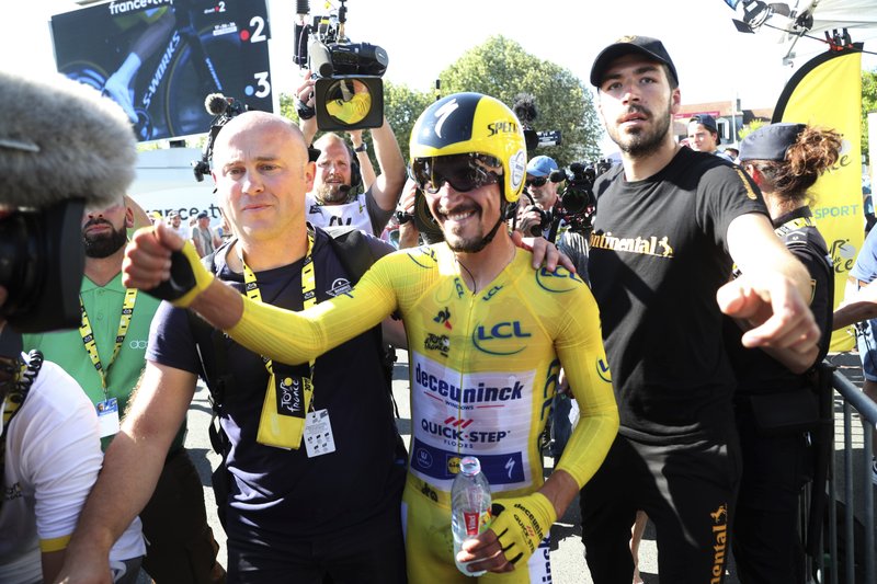 The Associated Press ALL SMILES: France's Julian Alaphilippe, wearing the overall leader's yellow jersey, celebrates Friday after winning the thirteenth stage of the Tour de France, an individual time trial over 27.2 kilometers (16.9 miles) with start and finish in Pau, France.