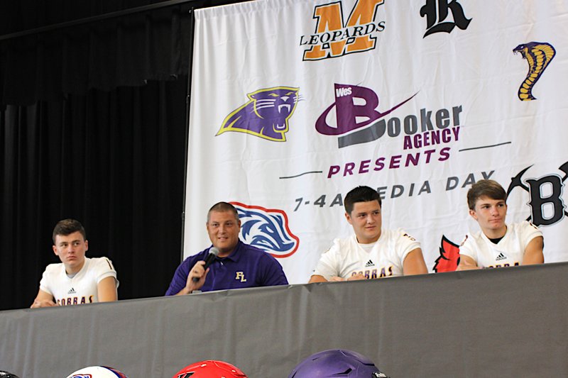 The Sentinel-Record/James Leigh COBRA CHATS: First-year Fountain Lake head football coach Brandon Barbaree, second from left, speaks to reporters during the second annual 7-4A Media Day at Joe T. Robinson High School Friday. Barbaree was joined on the stage by senior quarterback Ian Lacy, senior tight end Brett Barbaree and junior multi-position athlete Jack Wurz.