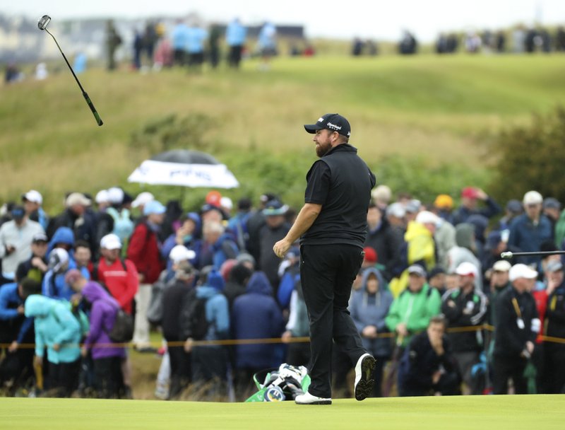 The Associated Press HIGH SPIRITS: Ireland's Shane Lowry throws his putter to his caddie on the 14th green Friday during the second round of the British Open at Royal Portrush in Northern Ireland.