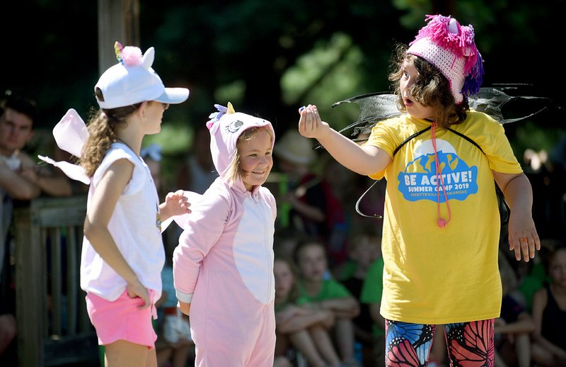 Beth Bakke (from left), 8, Harper Peck, 7, and Harper Henderson, 8, perform Friday in the play Goldicorn and the Three Dragons during Drama Camp at Gulley Park in Fayetteville. The weeklong camp, presented by Fayetteville Parks and Recreation in partnership with Pilot Arts, was attended by students ages 5 to 12 learned to act, write and perform on stage. NWA Democrat-Gazette/DAVID GOTTSCHALK