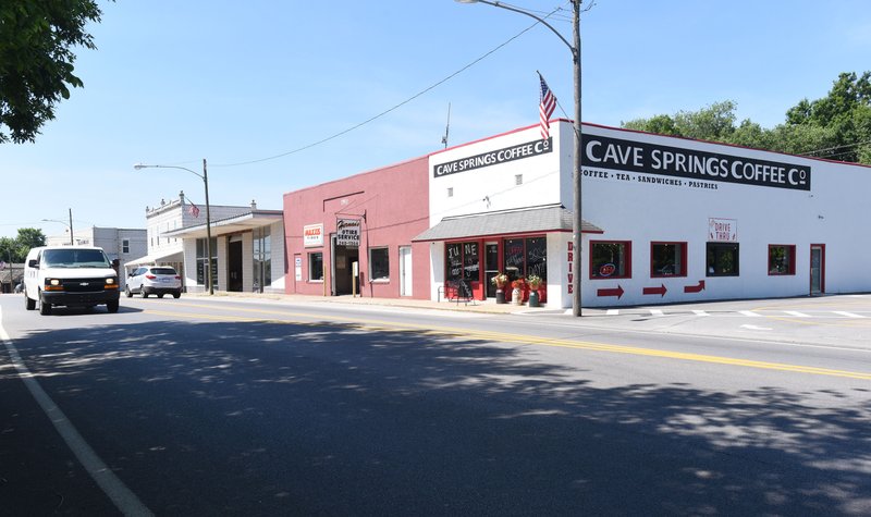 NWA Democrat-Gazette/FLIP PUTTHOFF Traffic passes through downtown Cave Springs on Wednesday, May 31, 2017.