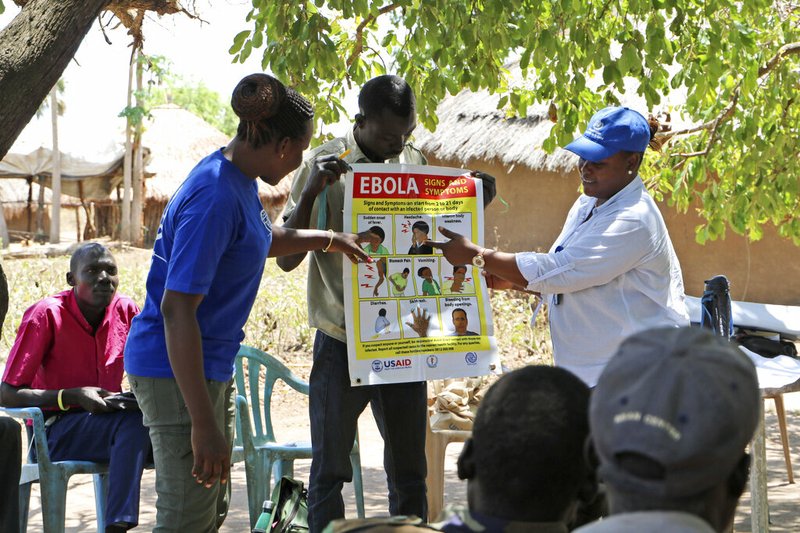 In this Tuesday Feb. 26 2019 photo, health workers give a training presentation about how to detect and prevent the spread of Ebola, in an army barracks outside South Sudan's town of Yei. With the deadly Ebola outbreak in Congo now an international emergency, neighboring South Sudan and its war-weakened health system is a major concern, especially after one case was confirmed near its border. Health experts say there is an urgent need to increase prevention efforts. (AP Photo/ Sam Medrick)