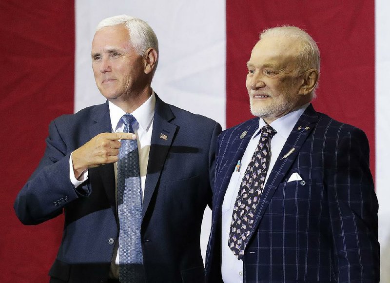 Vice President Mike Pence (left) points to Apollo 11 astronaut Buzz Aldrin during an event Saturday at the Kennedy Space Center in Florida in recognition of the 1969 moon landing anniversary. For more photos, go to arkansasonline.com/721apollo/. 