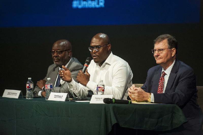 Flanked Saturday by Police Chief Keith Humphrey (left) and City Attorney Tom Carpenter, Little Rock Mayor Frank Scott Jr. answers an audience-member’s question during Saturday’s open forum held for the Hispanic community in Little Rock.