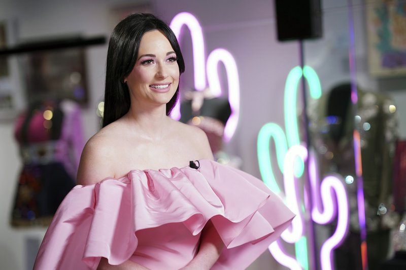 Country singer Kacey Musgraves poses in front of her new exhibit at the Country Music Hall of Fame and Museum in Nashville, Tenn. The exhibit runs through June 2020. (Photo by Donn Jones/Invision/AP)