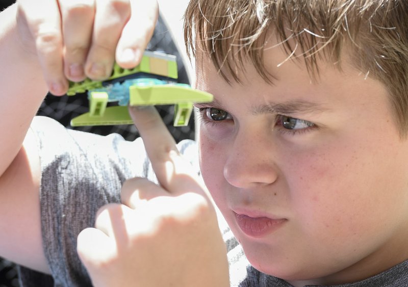 NWA Democrat-Gazette/CHARLIE KAIJO Connor Merideth, 10, of Oppelo builds a mini rover using Legos on Saturday at the Amazeum in Bentonville. The activity called "Lego We Do 2.0" allows kids to program their own rovers using an application and Legos. The Amazeum celebrated the 50th anniversary of the Apollo 11 moon landing. Activities featured included a robotics team with a rover and kids making their own mini rovers to test.