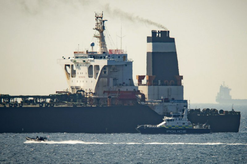 FILE - In this Thursday, July 4, 2019 file photo, a Royal Marine patrol vessel is seen beside the Grace 1 super tanker in the British territory of Gibraltar. Taken on its own, Iran's seizure of a British-flagged oil tanker in the Strait of Hormuz may seem like a brazen act of aggression, a provocative poke in the nose to both Britain and its chief ally, the United States. But Iran seems to view the armed takeover of the Stena Impero as a carefully calibrated response to the July 4 taking of an Iranian supertanker off the coast of Gibraltar, an operation in which Britain's Royal Marines played a major role. (AP Photo/Marcos Moreno, File)