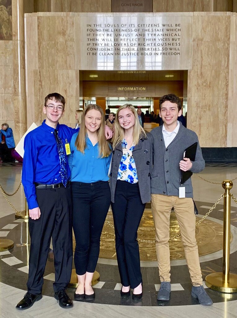 In this Feb. 6, 2019 photo provided by Providence Health &amp; Services, from left, Sam Adamson, Lori Riddle, Hailey Hardcastle, and Derek Evans pose at the Oregon State Capitol in Salem, Ore. The teens introduced legislation to allow students to take "mental health days" as they would sick days in an attempt to respond to a mental health crisis gripping the state. (Jessica Adamson/Providence Health &amp; Services via AP)