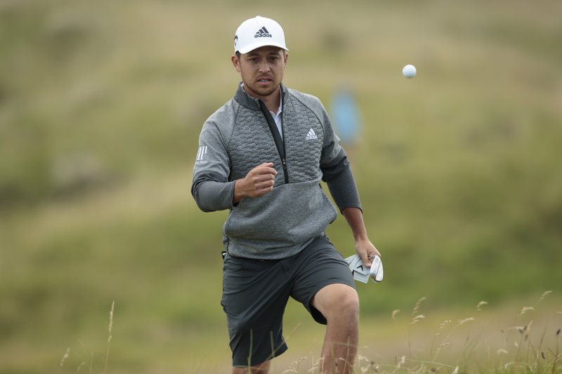 Xander Schauffele of the United States throws a ball near the 5th green during a practice round at Royal Portrush Golf Club, Northern Ireland, Monday, July 15, 2019.