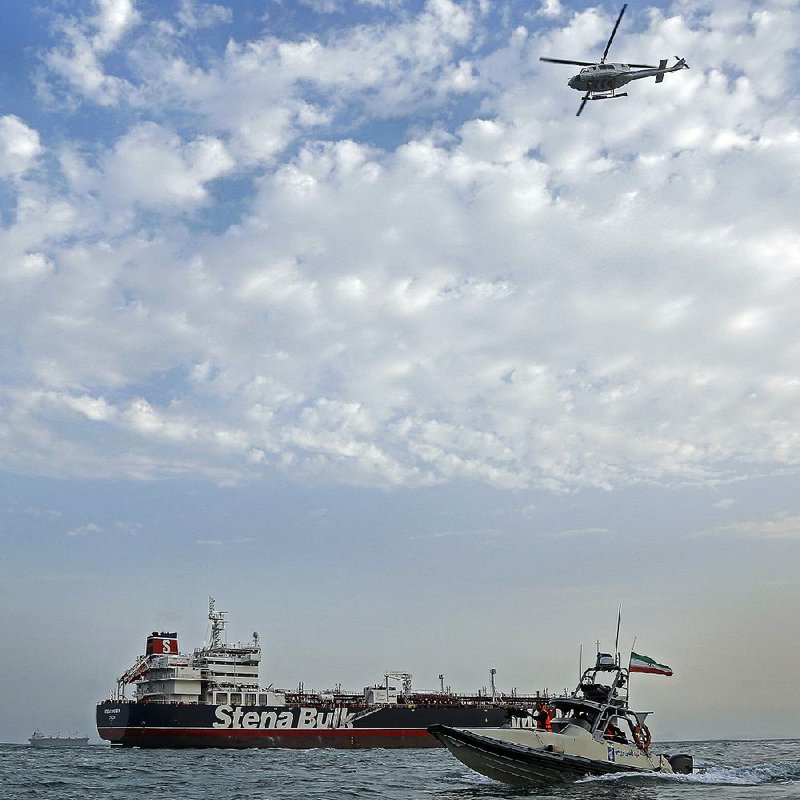 The seized oil tanker remains in the Iranian port of Bandar Abbas on Sunday as a speedboat and an Iranian Revolutionary Guard helicopter are seen nearby. 