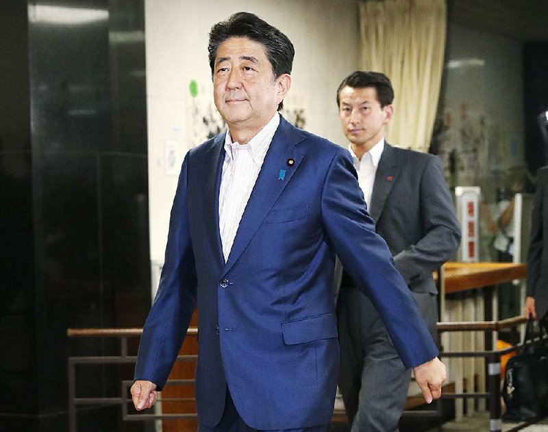 Japanese Prime Minister Shinzo Abe on Sunday enters the Tokyo headquarters of the Liberal Democratic Party. Abe welcomed the results of the parliamentary elections, saying he believed “the people chose political stability.” 