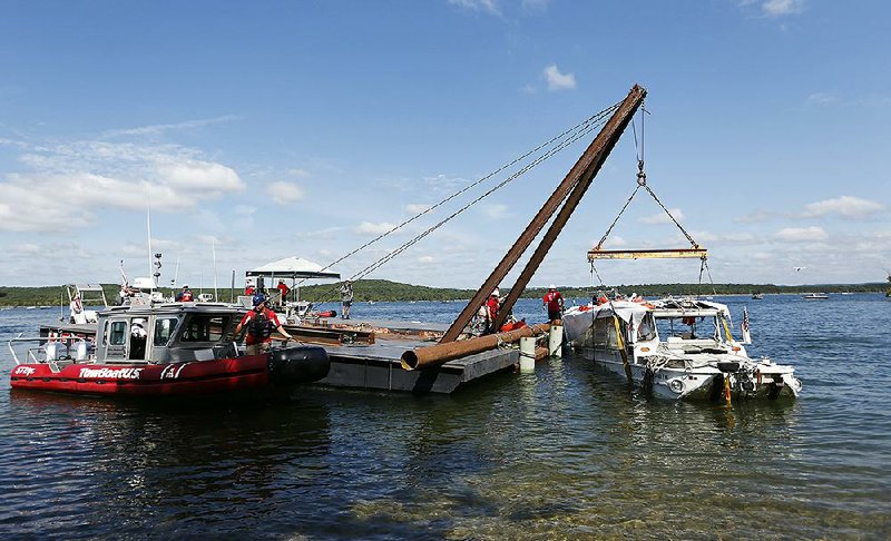 This file photo shows the duck boat that sank in Table Rock Lake in Branson, Mo., as it is being raised Monday, July 23, 2018. 