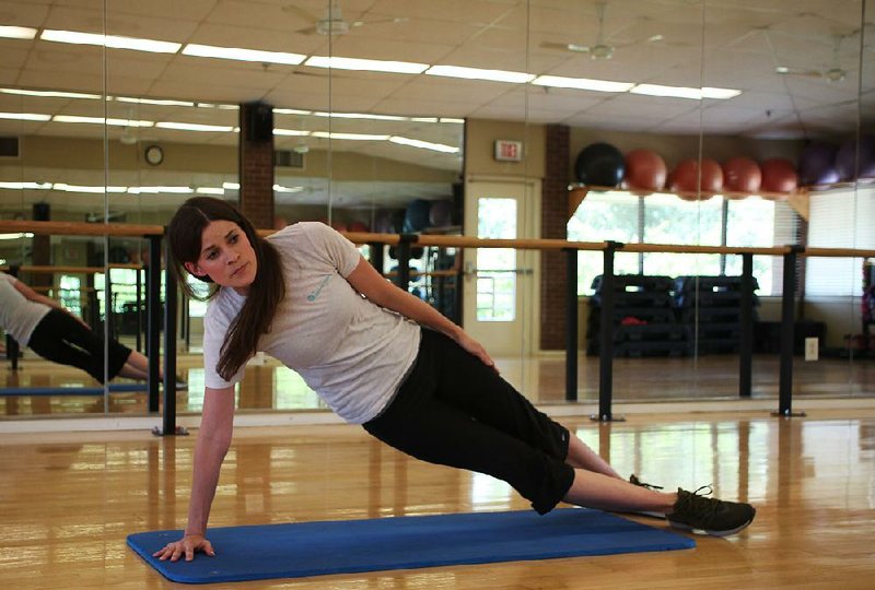 Amy Williams of Little Rock Racquet Club does step 1 of the Side Plank Windmill exercise.