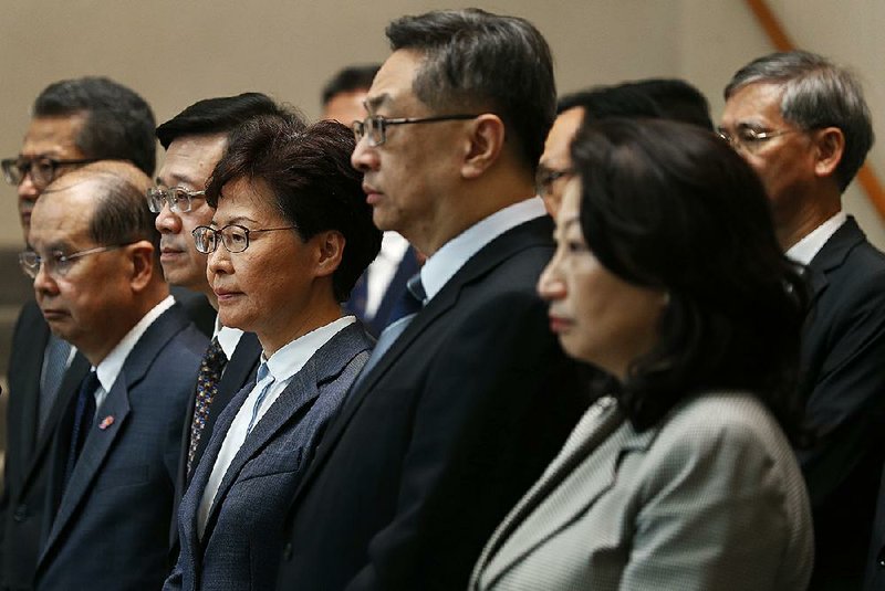 Hong Kong leader Carrie Lam (center) responded Monday to the acts of vandalism by some of those protesting China’s influence in the city, with Lam saying that such actions “hurt the nation’s feelings.” 