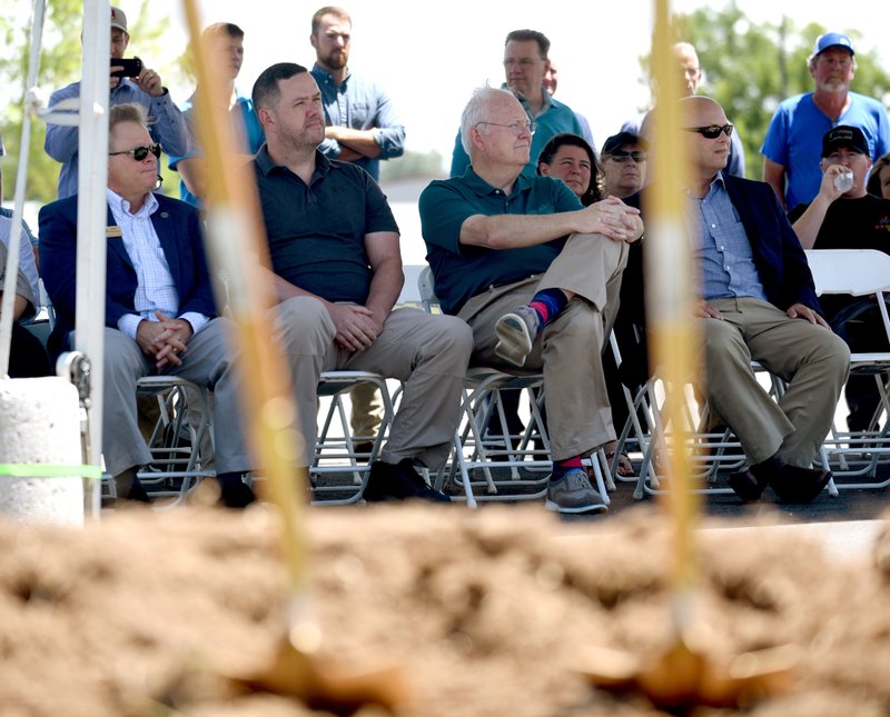 City, state and county officials listen Monday, July 22, 2019 to Steve Lawrence, with the Arkansas Department of Transportation, during a ground breaking ceremony for the extension of Dixieland Road near J.B. Hunt Corporate Drive in Lowell. The extension will connect Rogers and Lowell with the city of Springdale.