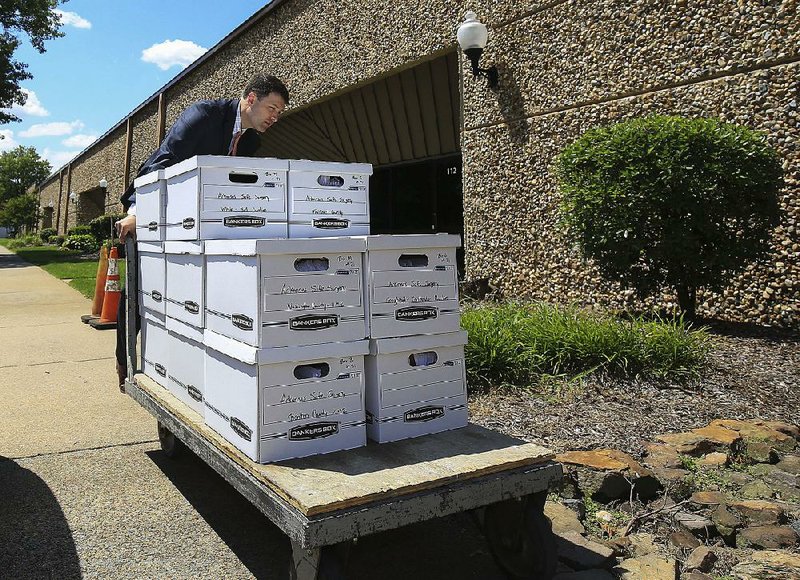 FILE — Alex Gray, an attorney for the Safe Surgery Committee, delivers petitions with more than 84,000 signatures to the secretary of state’s office in a bid to refer a new optometrists law to the people to vote on in 2020. 
