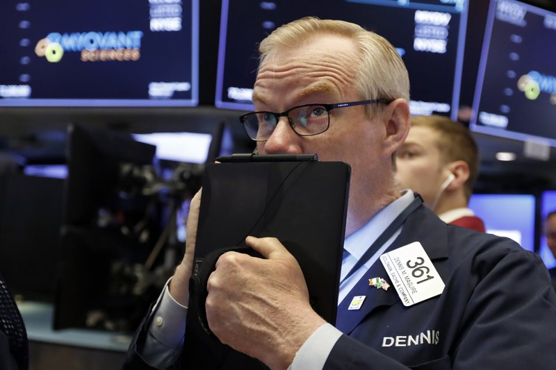 In this Thursday, July 18, 2019, file photo trader Dennis Maguire works on the floor of the New York Stock Exchange.  (AP Photo/Richard Drew, File)