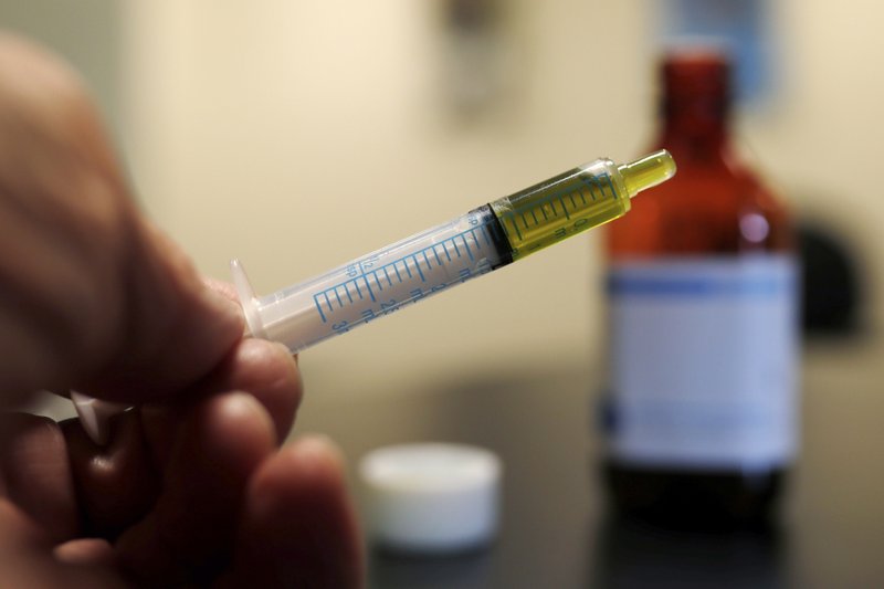  In this Nov. 6, 2017 file photo, a syringe with a dose of CBD oil is shown in a research laboratory in Fort Collins, Colo. CBD is a compound found in marijuana but doesn't cause a high.  (AP Photo/David Zalubowski, File)