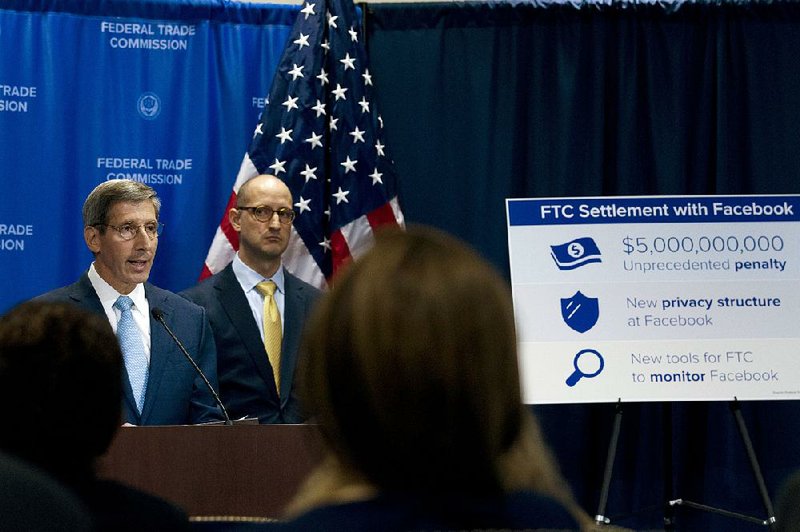 Federal Trade Commission Chairman Joe Simons (left) speaks during a Wednesday news conference in Washington about the Facebook settlement. 