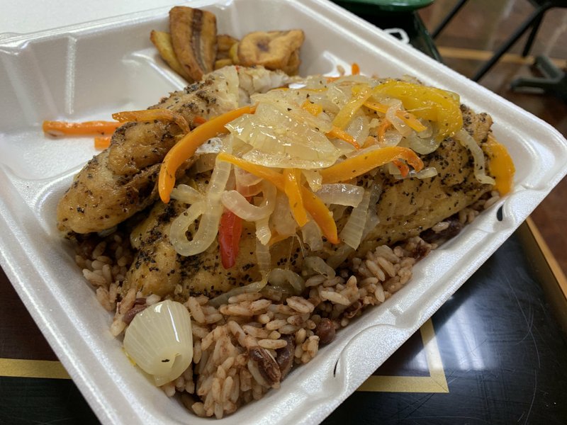 Snapper filets (served over rice and peas and with a side of fried plantains) are sometimes on the "line" at Taste of Jamaica on Little Rock's North Rodney Parham Road. Arkansas Democrat-Gazette/Eric E. Harrison
