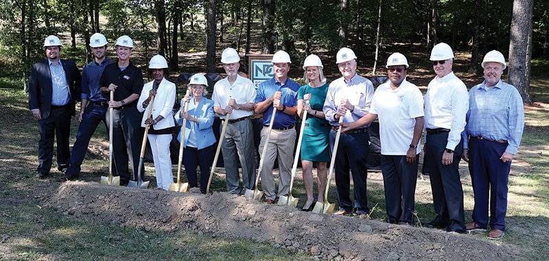 The Sentinel-Record/Richard Rasmussen COMING SOON: National Park College Board of Trustees members and others participate in a groundbreaking ceremony for the school's first student dormitory on Wednesday. From left are chief operating officer and president of Construction for the Annex Group, Tom Tomaszewski; SGA President Harris Felton; NPC President John Hogan; Trustees Joyce Craft, Gail Ezelle, Don Harris, Forrest Spicher, Beverly Joe, Mike Bush, and Raymond Wright; Servitas Senior Vice President of Finance and Administration Blair Tavenner; and Servitas Vice President of Asset Management David Braden.