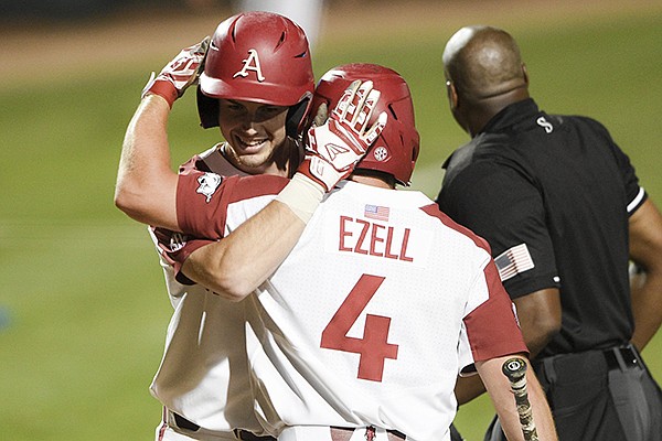 Arkansas designated hitter Matt Goodheart (10) hugs Trevor Ezell (4) after a score during an NCAA regional game against TCU on Sunday, June 2, 2019, in Fayetteville. Arkansas designated hitter Matt Goodheart (10) hugs Trevor Ezell (4) after a score during an NCAA regional game against TCU on Sunday, June 2, 2019, in Fayetteville.