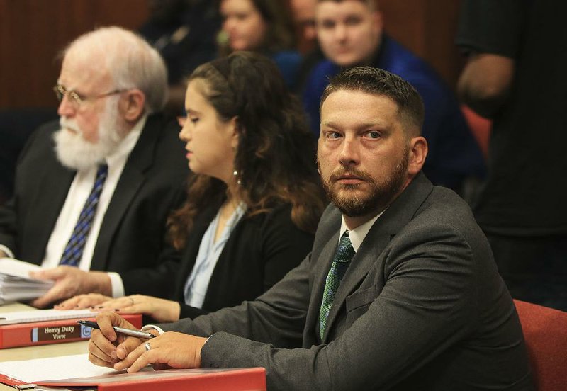 Former Little Rock police officer Charles Starks (right) waits for the start of his appeal hearing Thursday at Little Rock City Hall. The hearing, originally set to continue today, has been postponed indefinitely. More photos are available at arkansasonline.com/726hearing/ 