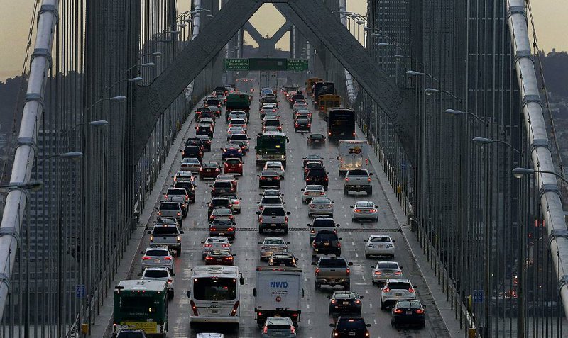 Vehicles cross the Bay Bridge toward San Francisco from Oakland in this December 2015 photo. Four major automakers have reached an agreement with California to cut engine emissions despite U.S. government plans to pare industry  regulations designed to reduce automobile pollution. 