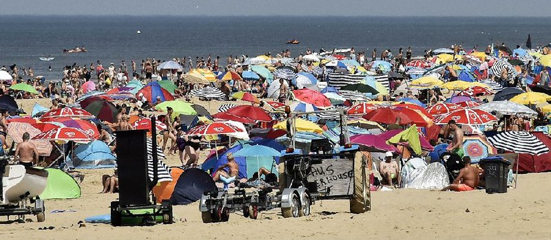 Bathers crowd a beach to beat the heat Thursday in Egmond in the northern Netherlands. 