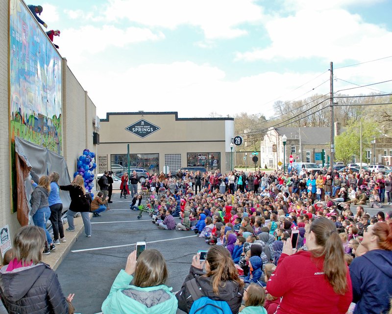 File Photo/NWA Democrat-Gazette/JANELLE JESSEN A new mural, designed by kindergarten students from Northside Elementary School, was revealed on Thursday in Siloam Springs. The mural is a result of a collaboration between the school, Main Street Siloam Springs, Art Feeds and Arvest Bank. It's on the side of the Arvest Bank building at the corner of Broadway Street and University Street.