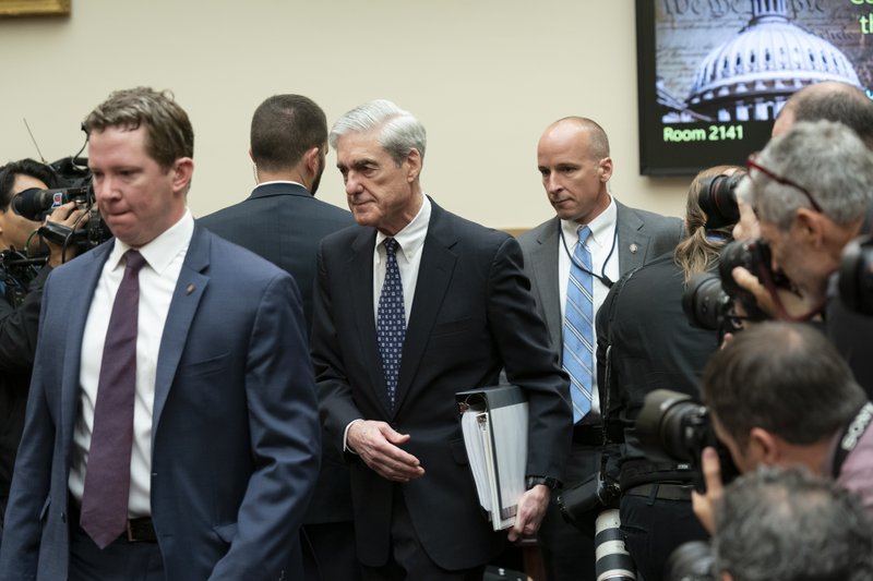 Escorted by a security detail, former special counsel Robert Mueller arrives to testify to the House Judiciary Committee about his investigation into President Donald Trump and Russian interference in the 2016 election, on Capitol Hill in Washington, Wednesday, July 24, 2019. Mueller told lawmakers he could not exonerate President Donald Trump of obstruction of justice and that the president's claims that he had done so in his report are not correct. (AP Photo/J. Scott Applewhite)