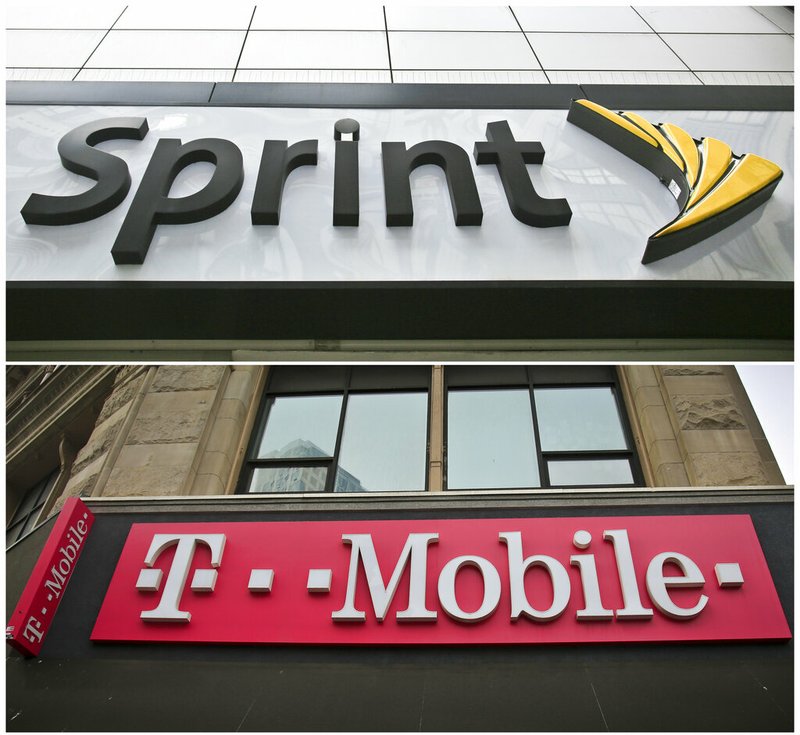 This combination of April 30, 2018, file photos shows signage for a Sprint store in New York's Herald Square, top, and signage at a T-Mobile store in New York U.S. regulators are approving T-Mobile's $26.5 billion takeover of rival Sprint, despite fears of higher prices and job cuts. (AP Photo/Bebeto Matthews, File)