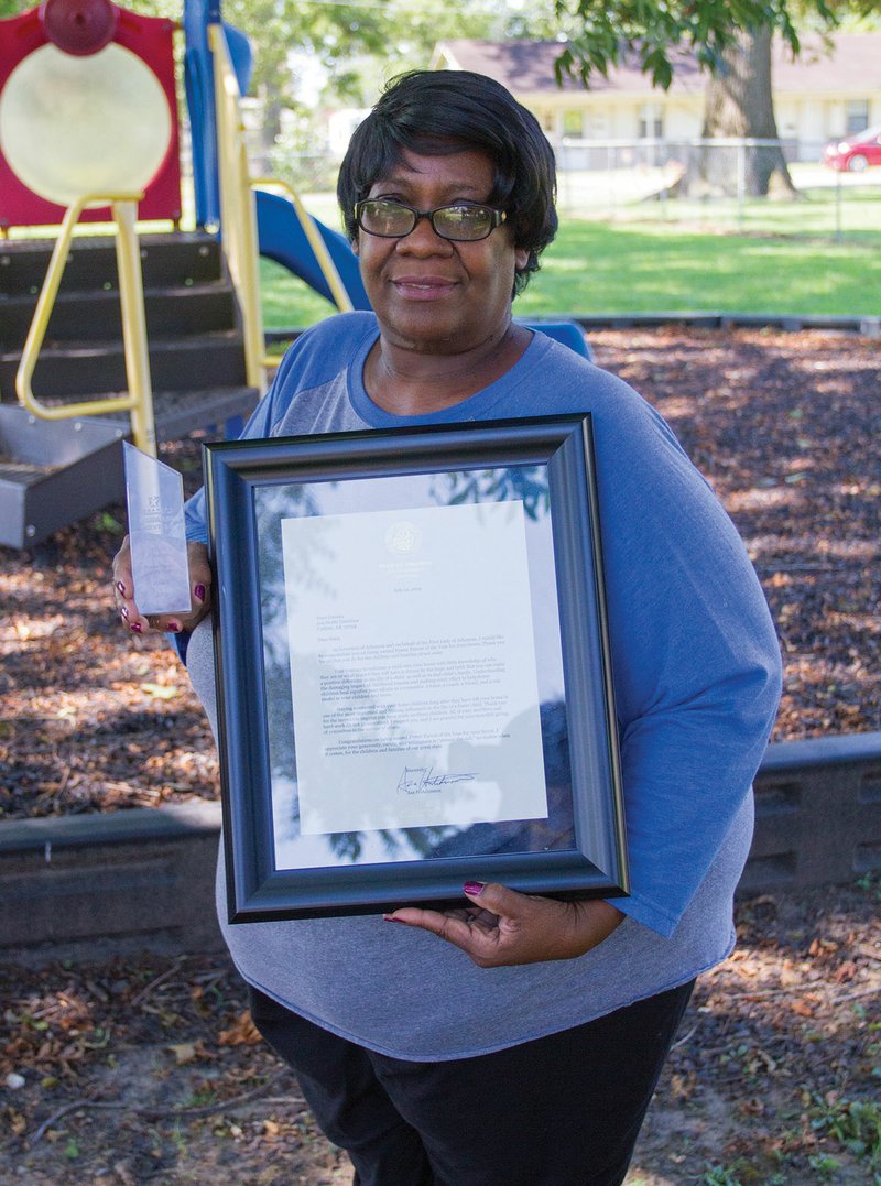 Nora Cooney of Lonoke holds her award and a citation from Gov. Asa Hutchinson for being honored as Foster Parent of the Year for Area 7 by the Arkansas Department of Human Services. Cooney has been a foster parent for about three years. She is a teacher with the Head Start Program in Lonoke.