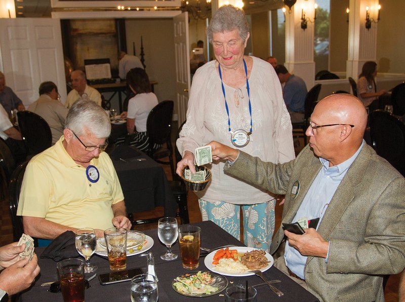 Irene Gray, executive secretary for the Rotary Club of Searcy, takes donations for the Arkansas Run for the Fallen from Ellis Sloan, right, and Jim Carr during the club’s weekly meeting Tuesday at the Searcy Country Club.