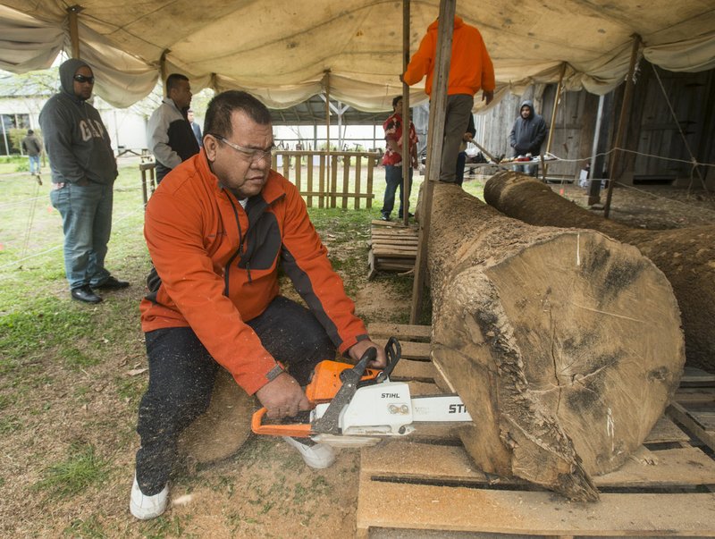 File Photo/NWA Democrat-Gazette/BEN GOFF &#8226; @NWABENGOFF Liton Beasa, master canoe builder, begins shaping a log in April 2018, during a ceremony to launch a project to build a Marshallese KorKor, a type of outrigger canoe, at the Shiloh Museum of Ozark History in Springdale.