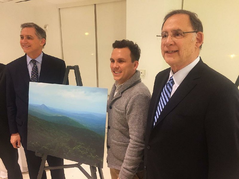 US Rep. French Hill, Anders Reynolds of the Pew Charitable Trusts and US Sen. John Boozman attend a reception Wednesday celebrating passage of legislation expanding Southern wilderness areas in Arkansas and Tennessee. 