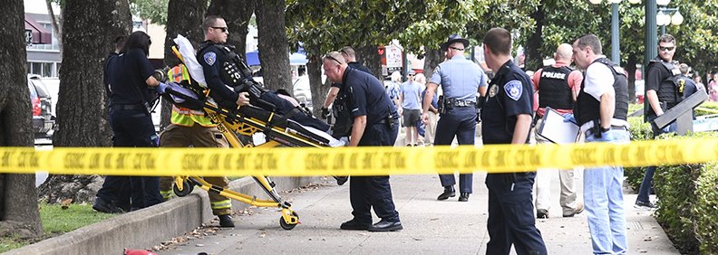 The Sentinel/Record/Grace Brown STABLE: First responders transport Hot Spring Police Officer 1st Class Johnathan Smith to an ambulance after he was reportedly shot twice near the south end of Bathhouse Row around 12:30 p.m. on Sunday. He was listed in stable condition upon arriving to the hospital and reportedly released the same day.