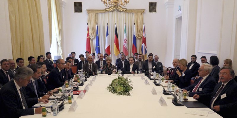 The European Union's political director Helga Schmid and Iran's deputy Foreign Minister Abbas Araghchi, center from left, wait for a bilateral meeting as part of the closed-door nuclear talks with Iran at a hotel in Vienna, Austria, Sunday, July 28, 2019.